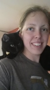 cat sitting on person's shoulders